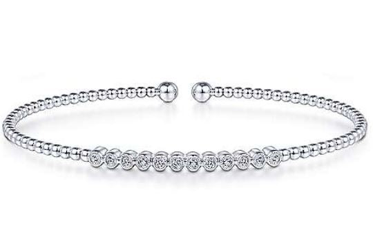 Crisp pave diamonds take center stage in this white gold bangle.